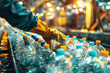 © Ninaveter - conveyor belt at plastic processing factory. worker's hands in gloves sorting plastic bottles