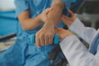 © Phanphen - Physiotherapist man giving exercise with dumbbell treatment About Arm and Shoulder of athlete male patient Physical therapy concept