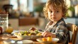 © twentyone - A little boy having a breakfast in a kitchen in the morning