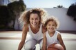 Joyous mother and child sharing a playful moment with a basketball, full of life and family fun.