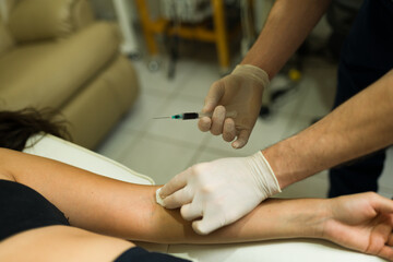 Wall Mural - Latin woman getting plasma injections and PRP therapy