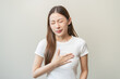 © Pormezz - Acid reflux disease, suffer asian young woman have symptom gastroesophageal, esophageal, stomach ache and heartburn pain hand on chest from digestion problem after eat food