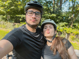 Fototapeta Krajobraz - Selfie of a young couple biking in the morning on a summer day