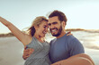 © Marko Geber - Couple laughing on the beach at sunset