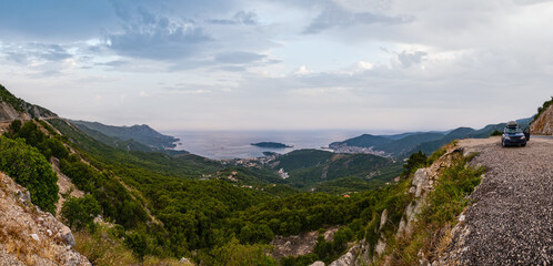 Wall Mural - Budva riviera coastline. Montenegro, Balkans, Adriatic sea. View from the top of the mountain road path.