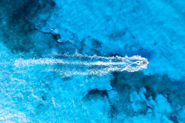 Wall Mural - vacation and leisure. aerial view on fast boat on blue mediterranean sea at sunny day. fast ship on 