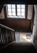 Interior of an old, wooden, pre war, neglected staircase in residential building. Daytime. No people.