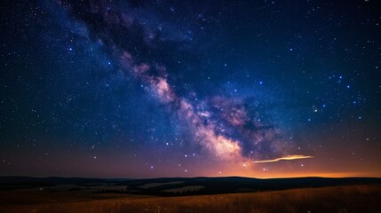 Wall Mural - The serene landscape under a rich star-filled sky with a hint of the Milky Way's presence