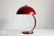Picture the retro lamp's striking crimson lampshade against a white background, radiating timeless charm.