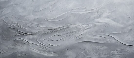 Canvas Print - A closeup of a swirling grey pattern on a liquid surface, resembling wind waves on the ocean. The transparent material creates a mesmerizing effect