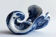 blue and white ceramic sculpture on white background 