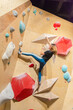 © ADDICTIVE STOCK - Indoor bouldering session with colorful climbing holds