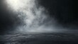 An atmospheric image showcasing a misty fog hovering over a dark, mysterious ground surface, imparting a sense of intrigue