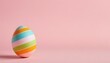 Easter decorated egg on a soft pink background with copy space