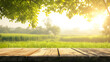 Empty display wooden table in front of green trees and farm background