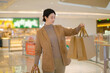 Confident Woman Enjoying Shopping Spree in Mall