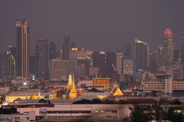 Golden pagoda at Temple of the Emerald Buddha in Bangkok, Thailand. Wat Phra Kaew and Grand palace in old town, urban city. Buddhist temple, Thai architecture. A tourist attraction.