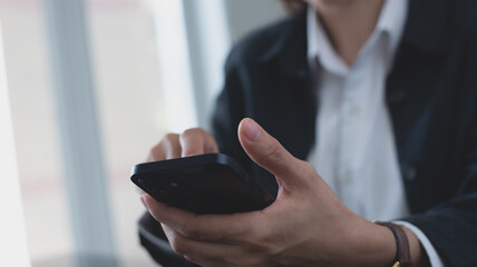 Poster - Close up, business woman using mobile phone at modern office. Businesswoman hand holding smartphone, surfing the internet, social media networking with copy space