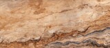 Fototapeta Desenie - A close up of a bedrock outcrop with a marble texture, featuring a beige and brown pattern resembling hardwood flooring. The landscape showcases the natural beauty of the rock wall