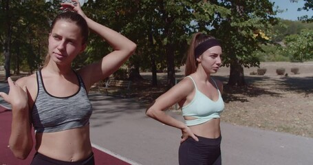 Sticker - An image capturing the essence of friendship and fitness with three women preparing for running in a urban park at the city.