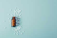 A Glas Bottle And Scattered Pills On A Light Blue Background With Copyspace