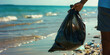 African-American volunteer collects plastic rubbish garbage on the ocean shore. Legs close-up. The concept of environmental conservation. Global environmental pollution. Cleaning of the coastal zone.