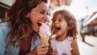 © Chamli_Pr - single mother and daughter eating ice cream outdoors on a summer evening, mother and daughter bonding, Good relations of parent and child. Happy moments concept