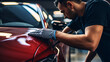 An auto detailer inspecting the paint surface for damages, Car detailing, and polishing concept