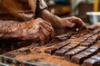 Close-up of a master chocolatiers hands crafting an artisan chocolate focusing on the precision and care in the tempering process