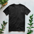 Black t-shirt beside plant on table. Minimalist and modern t-shirt mock up.