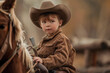 little boy in a cowboy costume, wearing a hat, riding a pony