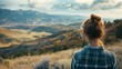 whide shot, woman looking away from the camera to the wide nature, mountains, clouds, sun, copy space, 16:9