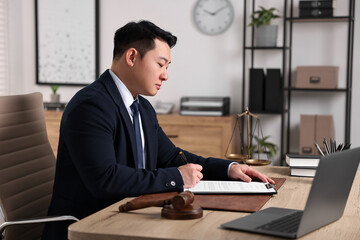 Sticker - Notary writing notes at wooden table in office