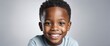 Plain bright silver background Portrait of black african smiling happy cute kid boy, copy space banner template backdrop from Generative AI