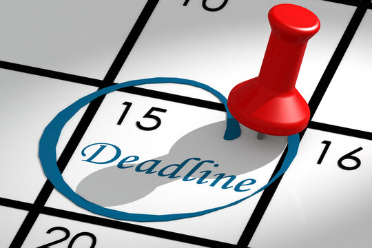 Deadline word marked on calendar with push pin