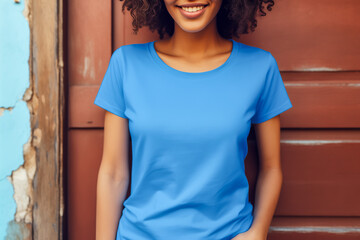 Wall Mural - Young woman wearing blank blue t-shirt. Mockup t-shirt template. Closeup, copy space.	