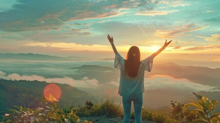 Wall Mural - A woman standing on top of a mountain at sunset. Ideal for travel and adventure concepts