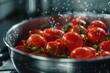 Fresh red tomatoes in a metal bowl, perfect for food and cooking concepts
