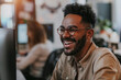© BrightSpace - happy man with glasses is smiling and laughing while sitting in front of a computer monitor. Concept of happiness and enjoyment, as the man is having a good time while working or browsing the internet