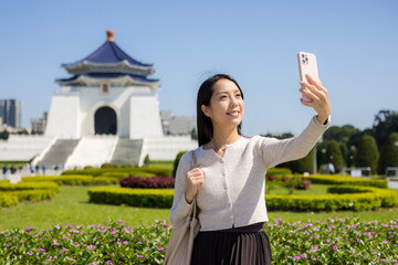 Poster - Tourist woman take photo on mobile phone in Chiang Kai shek Memorial Hall in Taipei of Taiwan