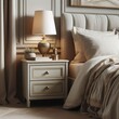 Close up of bedside cabinet near bed with beige bedding. French country interior design of modern bedroom
