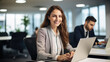 © Studio Nova - Happy woman working on a laptop in the office