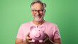 Smiling middle age man holding a piggybank