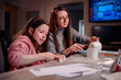 © Иванна Емельянова - The sheer delight of a girl sculpting with clay is shared with her mother, capturing the essence of joyous learning and creative expression within the family
