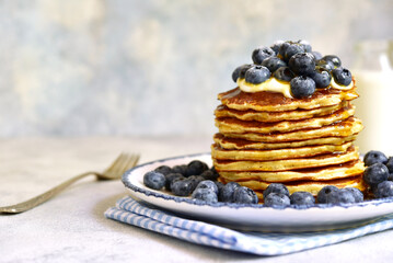 Wall Mural - Stack of fresh hot pancakes with maple syrup and blueberries.