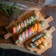 Set traditional Japanese sushi rolls on cutting boards. On rustic background