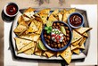 mexican food, nacho chips, sauce, vegetables, olives, abstract background