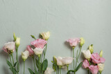 Bouquet of pink and white flowers of eustoma, lisianthus on a light green background with a place for text