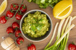 Homemade bowl of guacamole dip with fresh ingredients