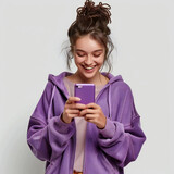 Fototapeta Sport - Portrait of positive girl using her smartphone reading social network news chatting with friends wear casual clothing